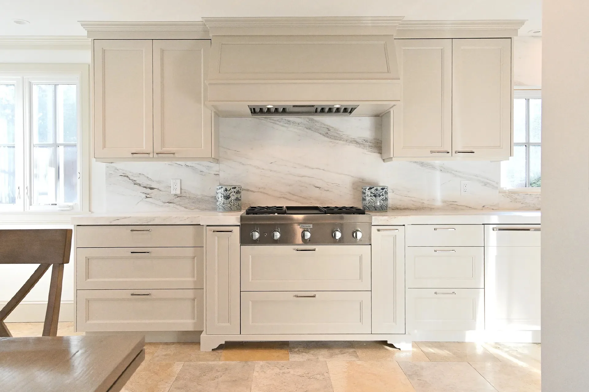 Custom kitchen with range hood by Millcreek Cabinet and Design